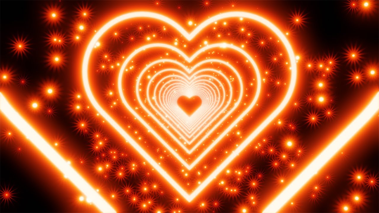 Red neon heart with hexagonal star shaped particles on a black background. 4K Video Loop