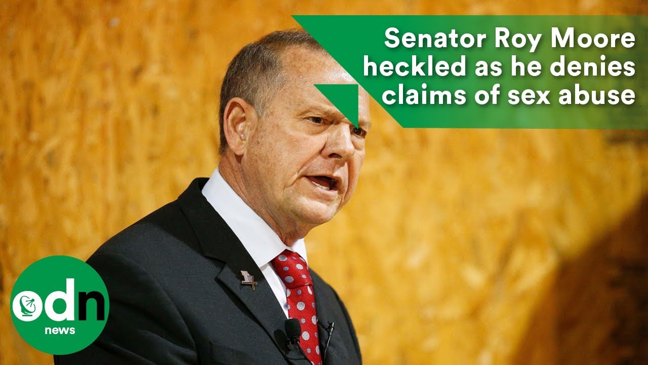 Roy Moore heckled as he denies claims of sex abuse
