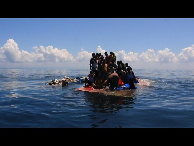 Indonesian authorities rescue stranded Rohingya holding onto overturned boat | AFP class=