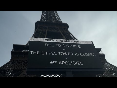 Workers at the landmark Eiffel Tower closing off the structure to tourists in protest