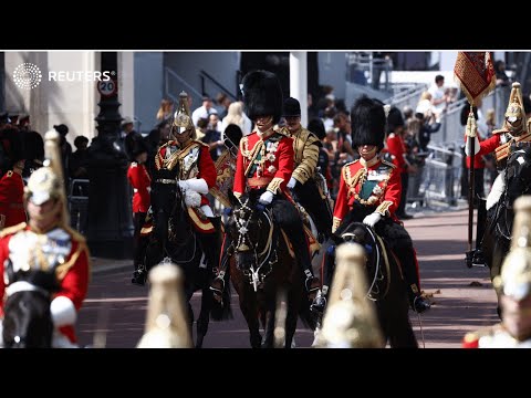 Prince Charles and William ride down Mall on horseback