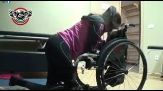 Woman Getting In Wheelchair.