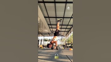 Guy Does Handstand Push-up While Balancing on Dumbbells