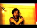 Behind the shower curtain.