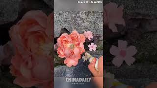 Clay flowers blooming on the wall