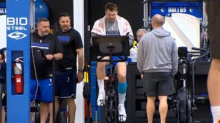 Mavs Luka Doncic rides stationary bike with compression sleeve on left leg