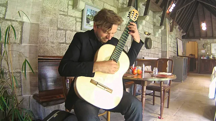 Marcin Dylla playing a spruce/maple guitar by Jame...