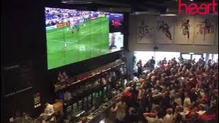 Fans in a bar cheering at soccer goal reaction meme/template