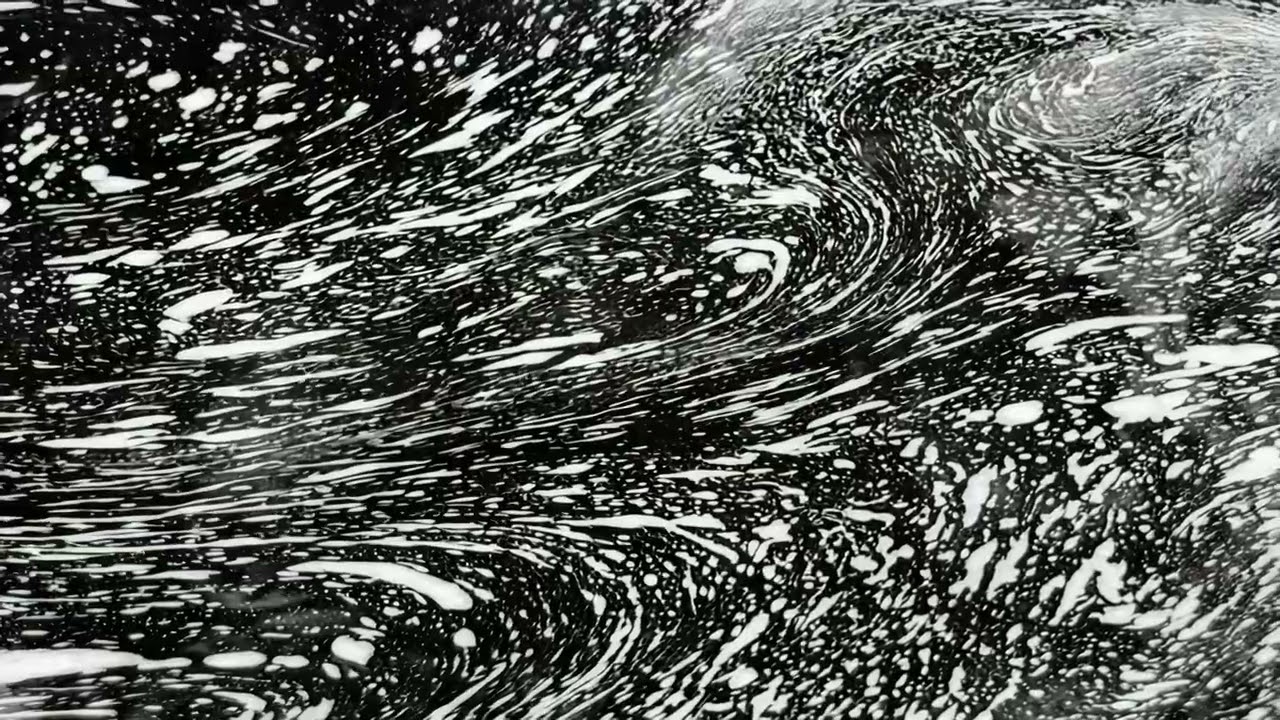Dynamic swirling water patterns in black and white close up abstract motion texture background