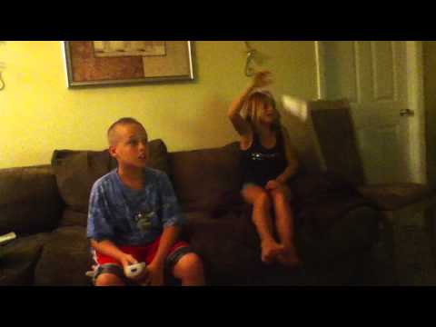 girl hits her self with the wii remote