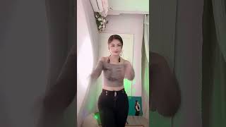 A mature Asian woman dancing and chatting。