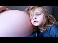 Sister reacts to baby moving inside mommys big pregnant belly