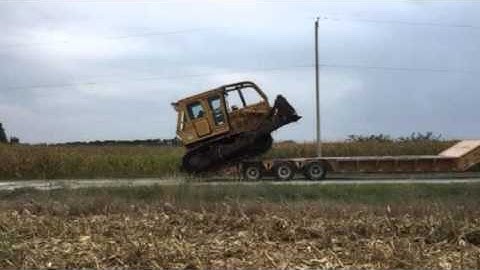 Loading bulldozer onto lowboy trailer