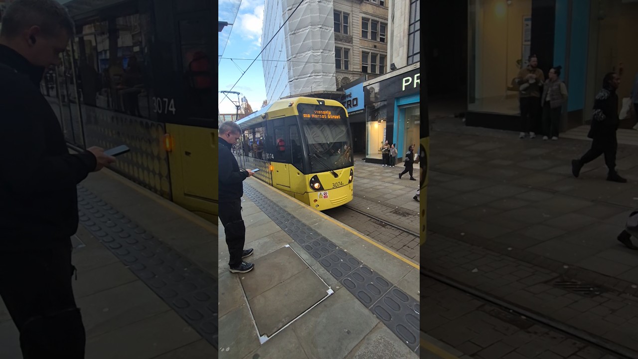 Manchester tram arrives into market street 