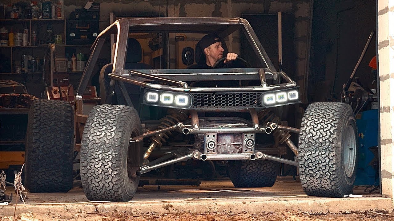 A man is building a unique all-terrain vehicle in a garage!
