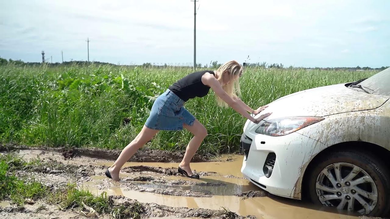 Sexy girl pushing car