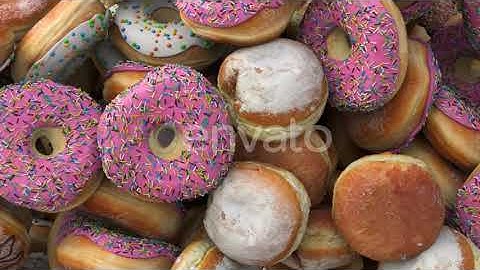 Falling Different Donuts on a Pink Background | Motion Graphics - Envato elements