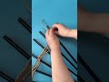 Large chopsticks form a wall ornament, framing a flower centerpiece with handmade rustic charm.