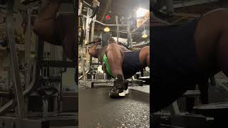 Hunch down crouch down butt glutes near ground incline seated chest press machine gym.