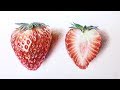 Drawing two strawberries with colored pencils.