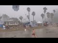 Parents Try to Protect Kids on Beach During Random Weather Occurrence
