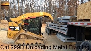 Cat 299D XHP Unloading the Framing for a 80x100 Metal Building