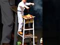 miniature of workers stirring spices on a ladder
