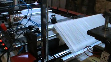 Automatic draw string ribbon through rolled garbage bag making machine