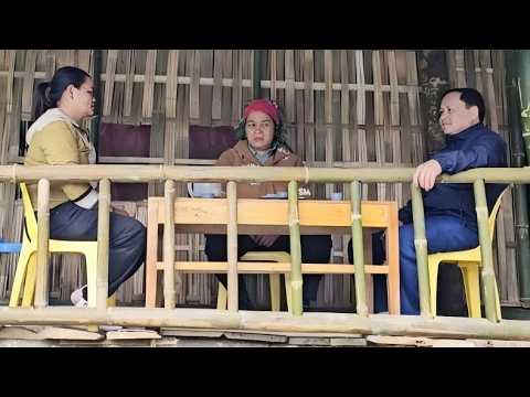 The loving mother stays up late lighting a fire to warm her sleeping son.