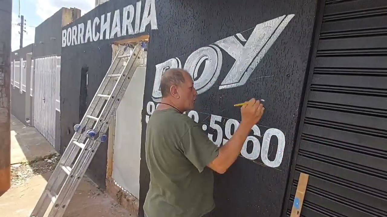 fazendo  letreiro no muro (anilton) artista de rua