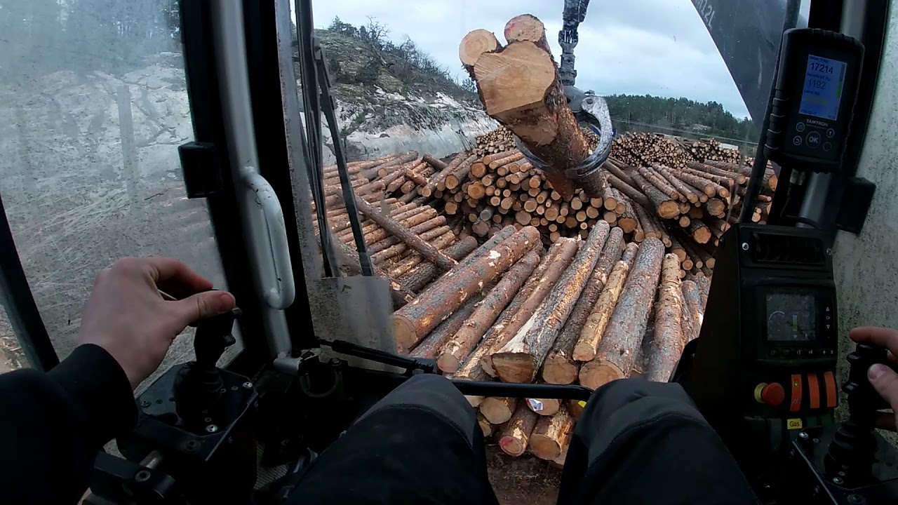 Unloading Timber From A Timber Truck