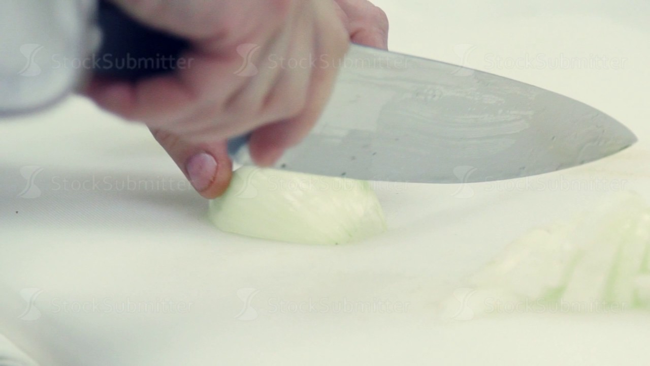 Slow motion. The chef's knife to cut onions on a cutting Board - YouTube
