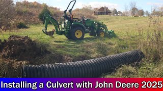 Installing a culvert with the John Deere 2025 tractor and backhoe attachment