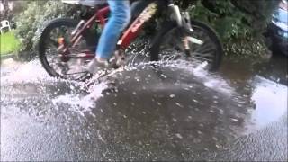 slow motion bike through puddle