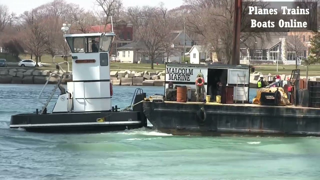 Construction Barge Pushed By Small Tug Boat