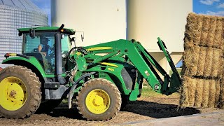 John Deere 7630 loader tractor unloading Big square perennial rye grass bales unloaded (farm vlog)