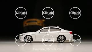 SLOW MOTION: Yellow toy car jumps and turns over across white toy car