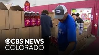 Veterans and volunteers pack food boxes to help Colorado families