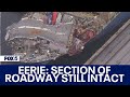 Baltimore Key Bridge collapse: Section of roadway that fell remains unbroken across container ship