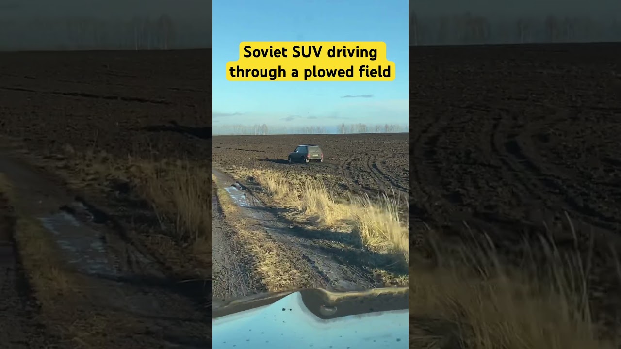 Soviet SUV driving through a plowed field