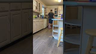 Toddler Hangs on Dad’s Leg as He Moves around the Kitchen