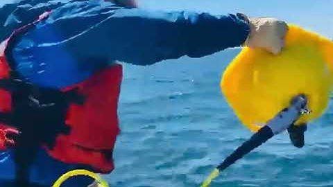 Throwing a Spotter Drifter Buoy into Lake Superior