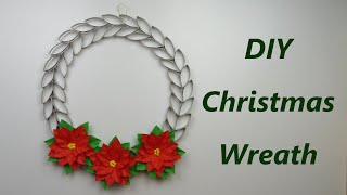 Wreath made of toilet paper rolls with paper poinsettia flowers. DIY Christmas decorations