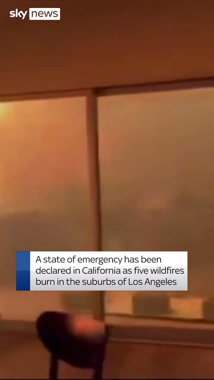 House surrounded by flames amid wildfire
