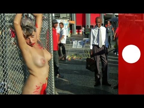 Chained naked to a fence, woman protests against sexism in Brazil