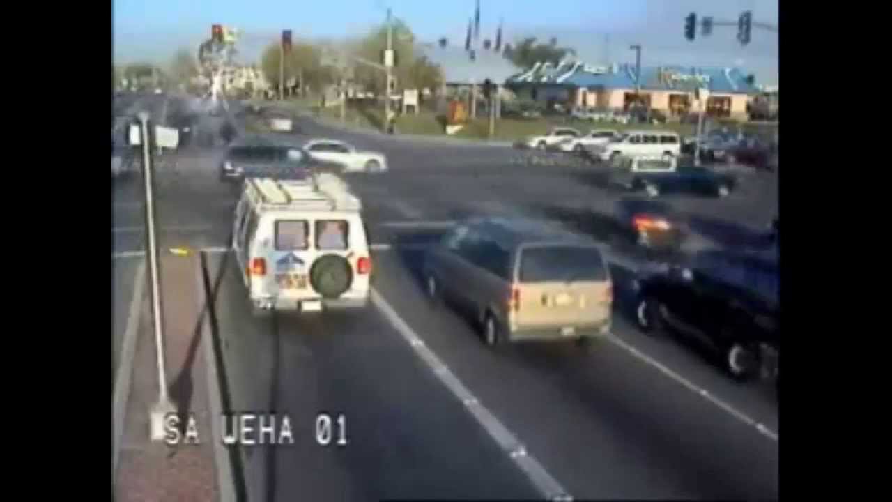 Real life Frogger video game - car runs red light at busy intersection in rushhour traffic