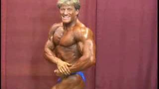 NPC bodybuilder Stacy Seals posing backstage