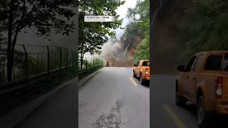 Truck reverses to escape mountainside landslide collapse in southern China