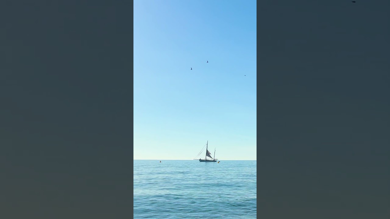 Somewhere between the sea and the sky, a sailboat decided to stay.