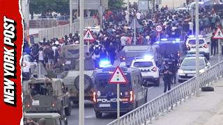 Military and Police Escort Swarm of Migrants Out of Spain's Ceuta Enclave
